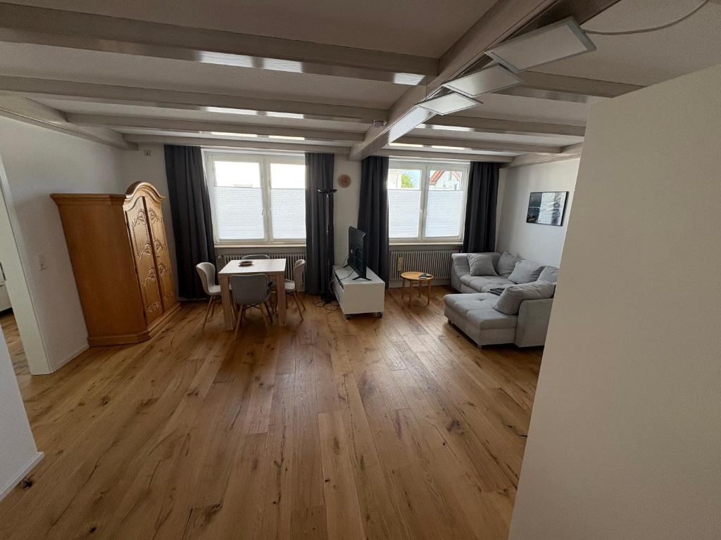 a living room with a couch and a table at Moderne Ferienwohnung Bodensee in Sigmarszell