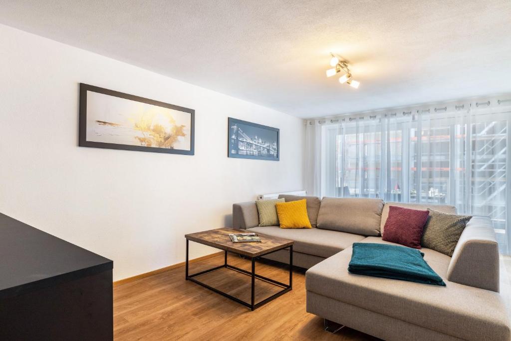 a living room with a couch and a table at Apartments Winder 2 in Lustenau