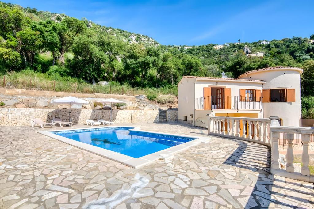 a villa with a swimming pool and a house at Villa Speranza by Easy Brava in Calonge