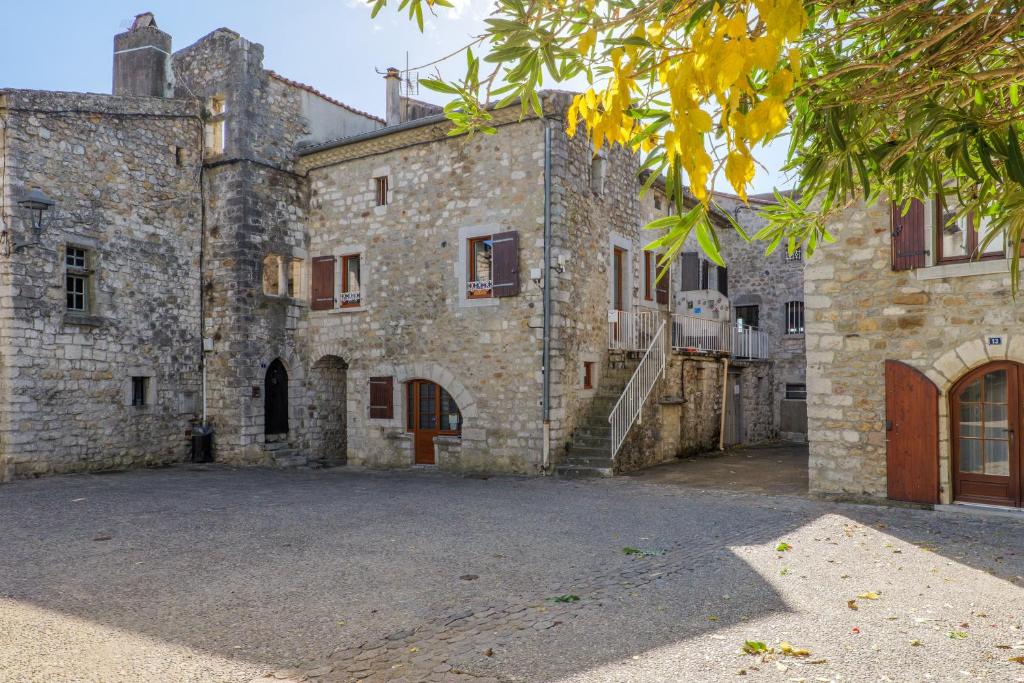 an old stone building with a staircase in front of it at Gite Leoannatim in Ruoms