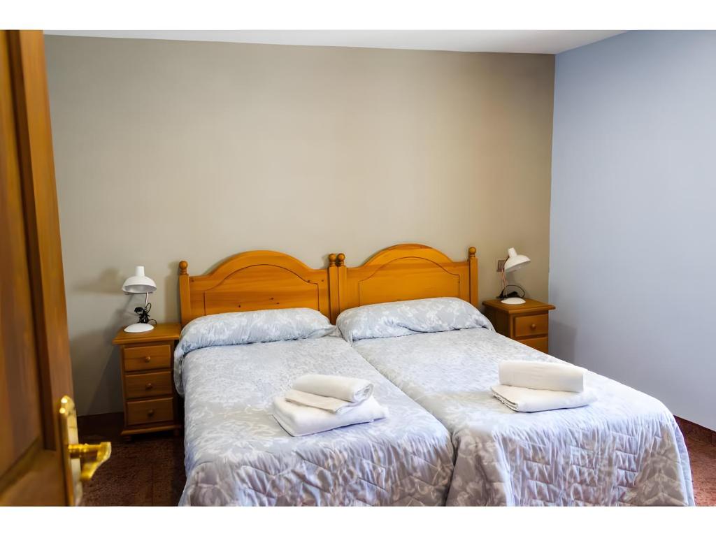 a bedroom with a bed with two towels on it at Nogal in Hospital