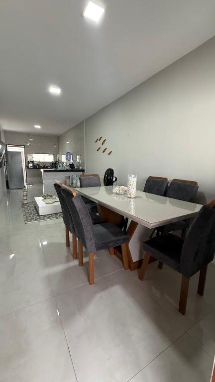 a dining room with a table and chairs at Casa em tibau in Tibau