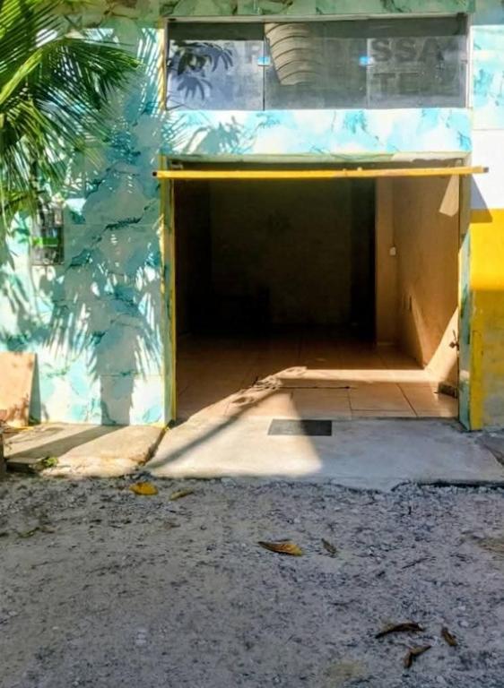 a garage with the door open in a building at Pousada Vó Ana Reis in Aparecida