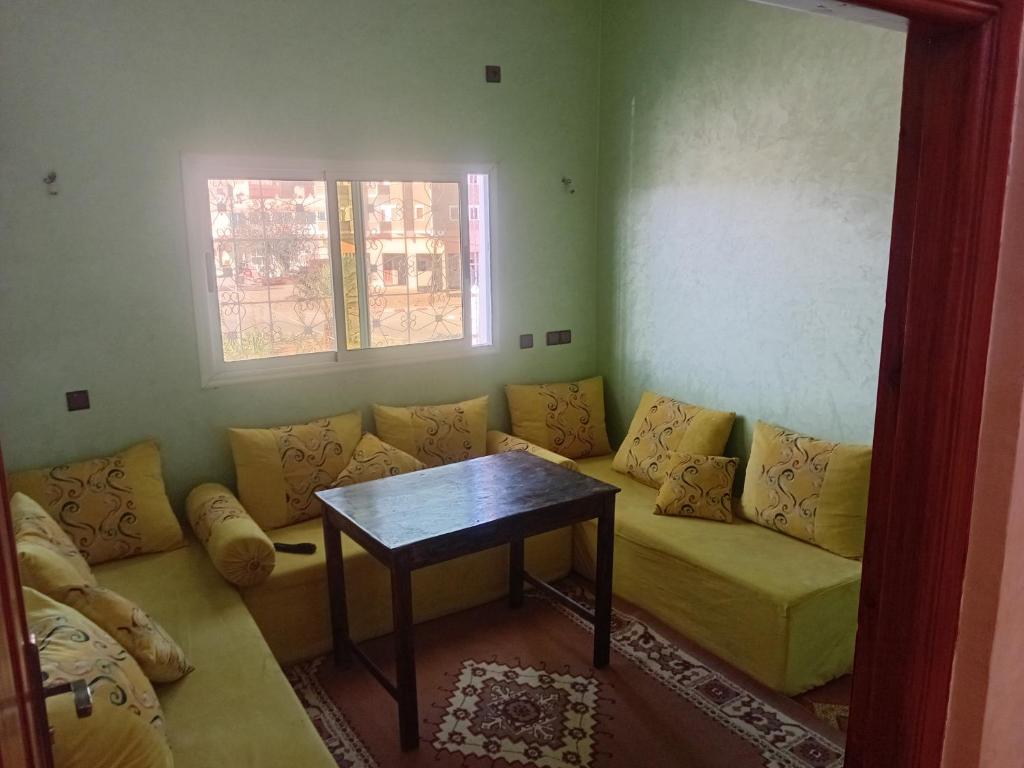 a living room with a couch and a table at شقة الياس in Agdz