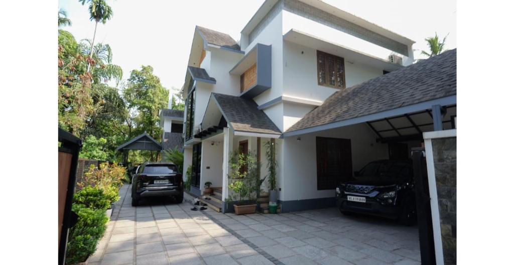 a house with a car parked in the driveway at CRK Home Stays in Cochin