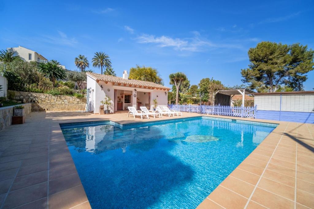 a villa with a swimming pool and a house at Romántica Jávea -Solo Familias 1769 in El Tosalet