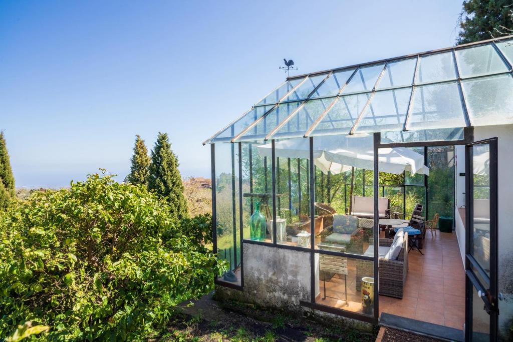 a glass house with a view of the countryside at Etnalodge in Piedimonte Etneo