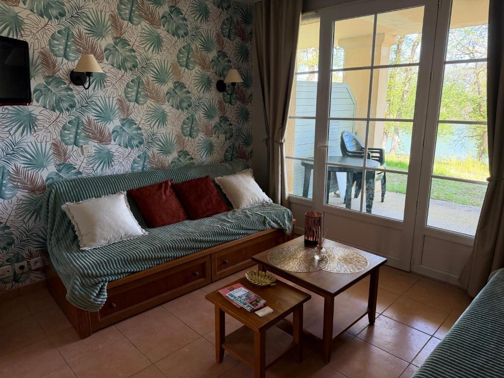 a living room with a couch and a table at Lake view Appartment in Monflanquin