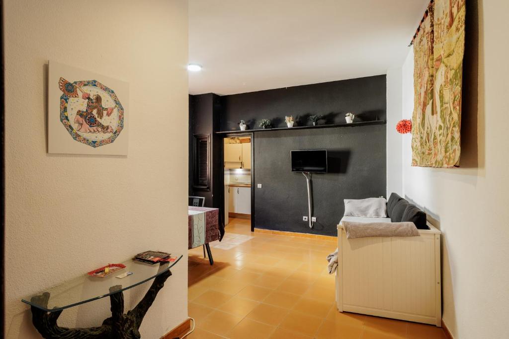 a living room with a couch and a glass table at Conde Center Premium Suites in Seville