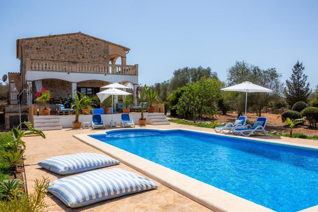 a villa with a swimming pool and a house at Oasis del Sol in Llombarts