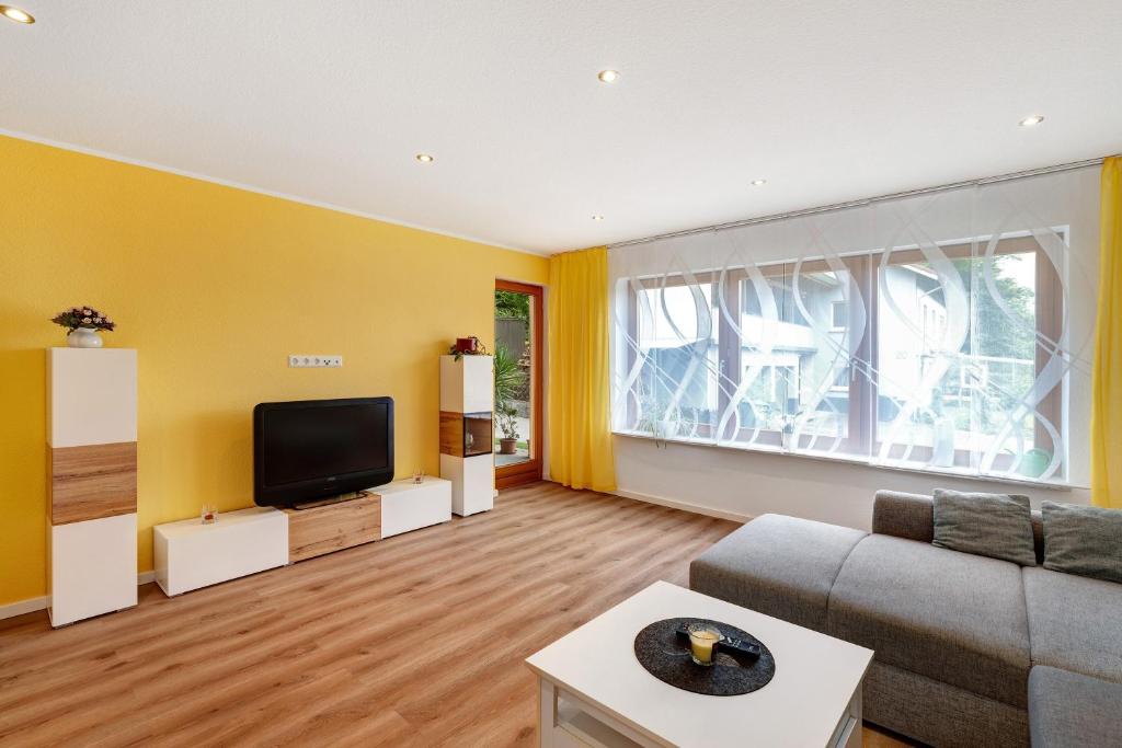 a living room with a couch and a tv at Ferienwohnung Käshammer in Kappelrodeck