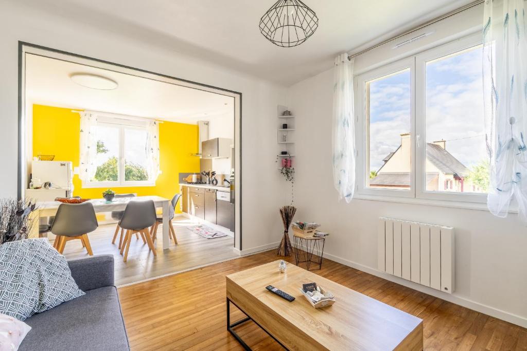 a living room with a couch and a table at Maison Ker Morin La Gacilly in La Gacilly