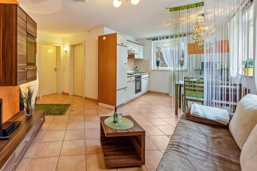 a living room with a couch and a table at Ferienwohnung Im Holzhaus in Donaueschingen