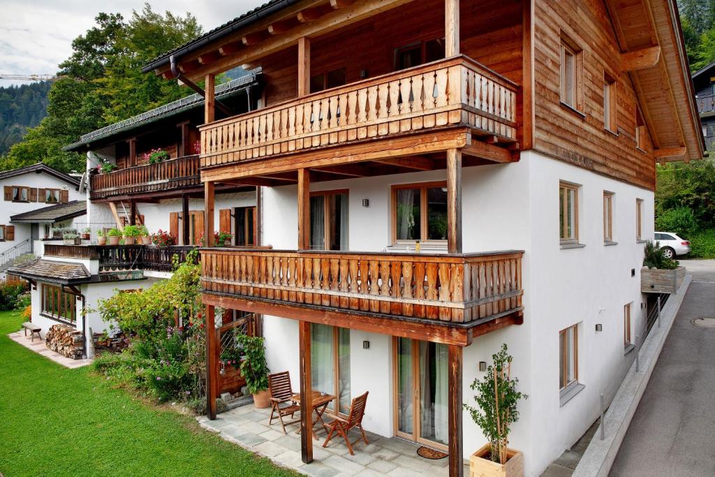 a house with wooden balconies on the side of it at Chalet Falkenstein in Garmisch-Partenkirchen