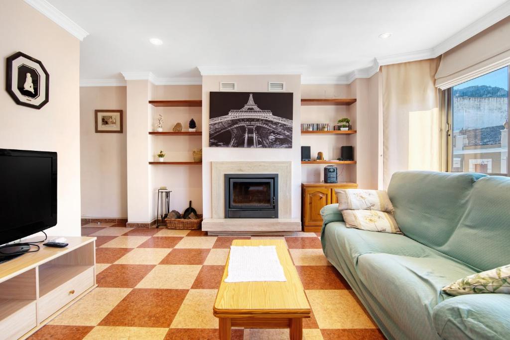 a living room with a couch and a fireplace at La bodegueta in Orba