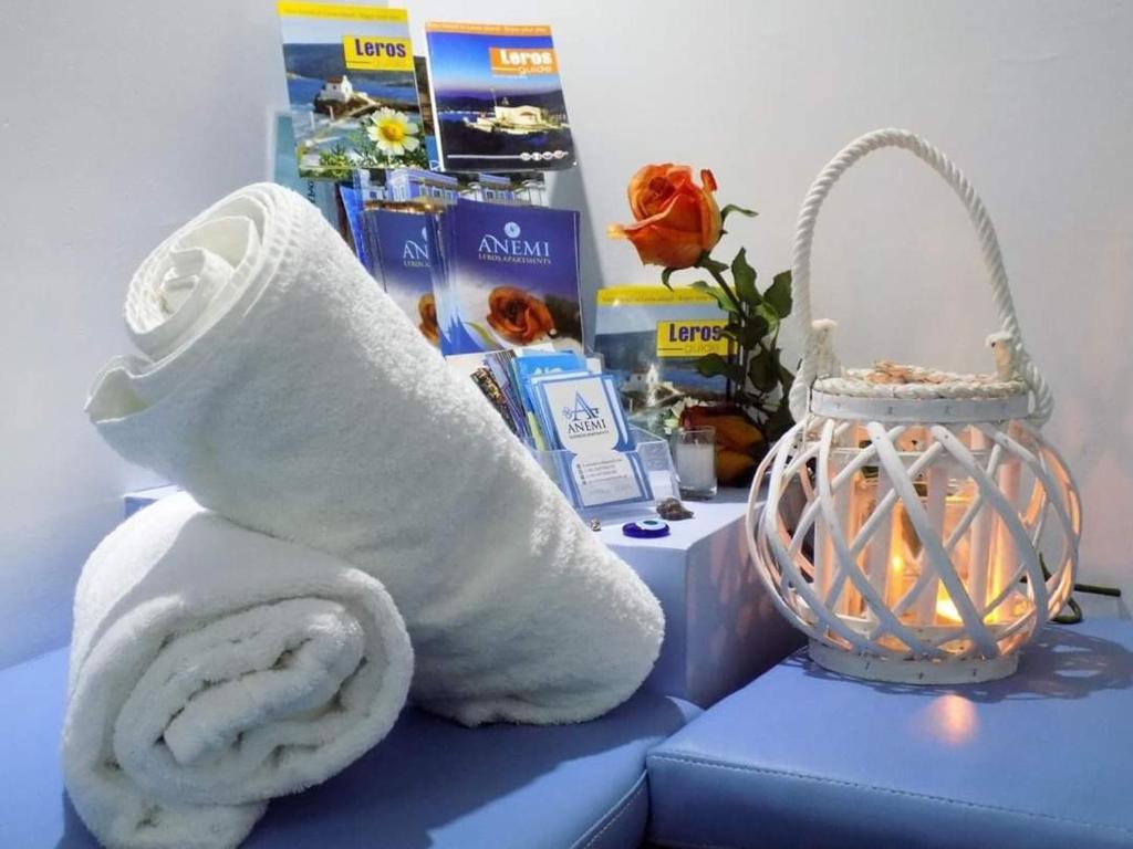 a roll of toilet paper sitting next to a lantern at Anemi Leros Apartments 2 in Panteli