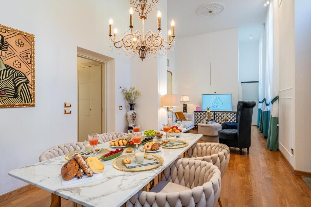 a dining room with a table with food on it at Maison Mirò with private parking in Lucca