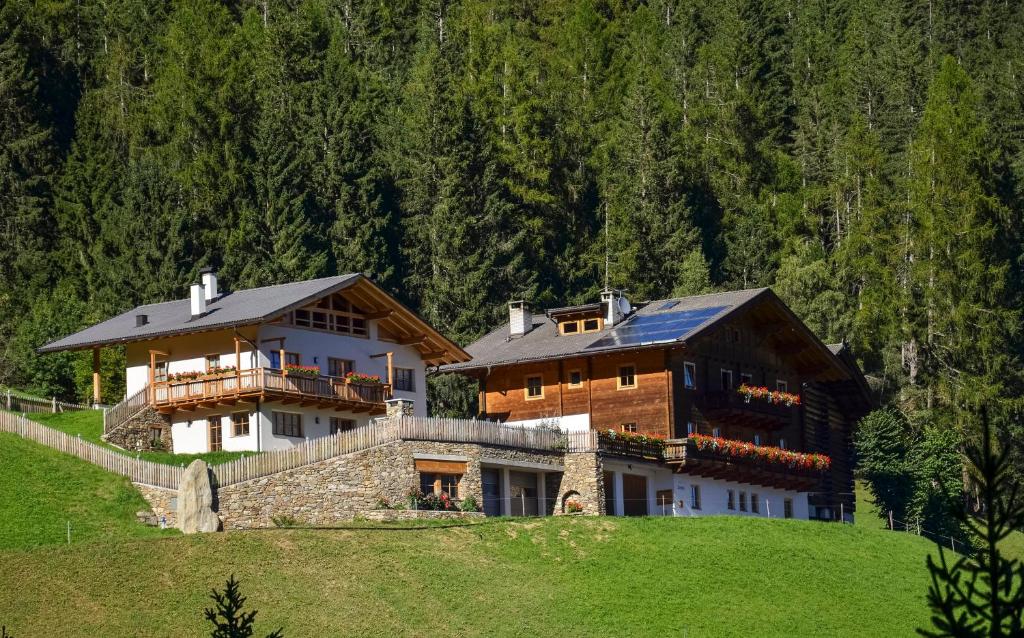 a large house on top of a hill at Thalhof Kornigl in Ultimo