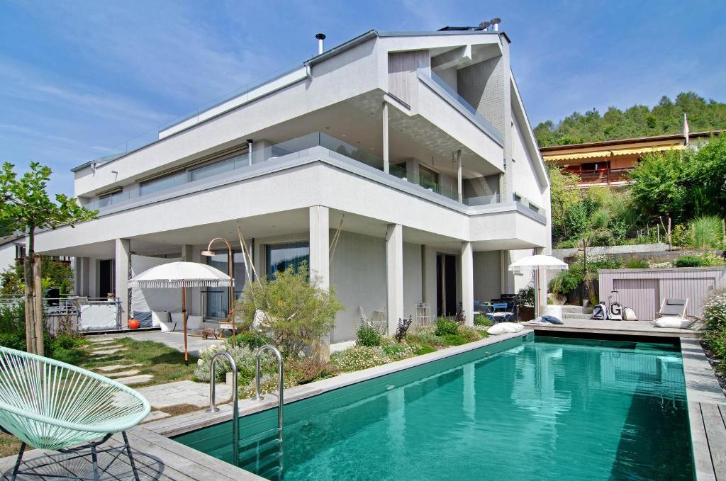 a house with a swimming pool in front of a house at Seeart-apartment No 86 in Ludwigshafen