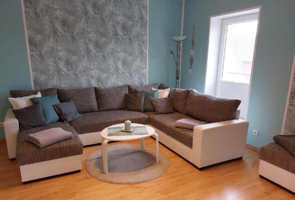 a living room with a couch and a table at Fewo 1 - Osterberg in Liebenau