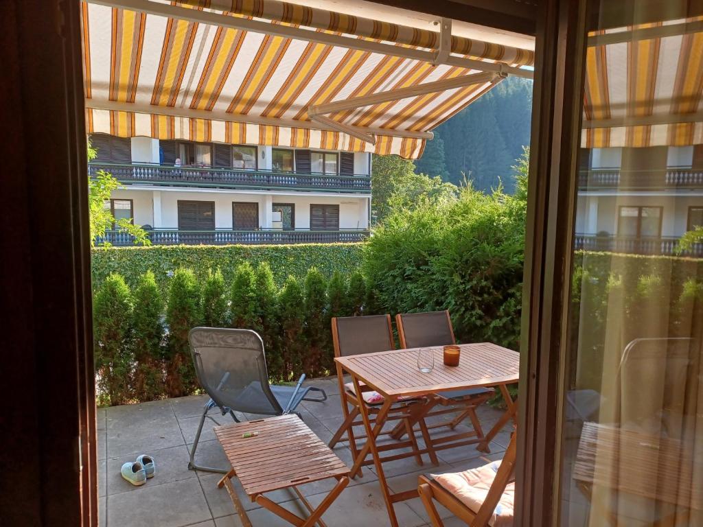 a patio with a table and chairs and a building at Somski Saalbach in Saalbach-Hinterglemm