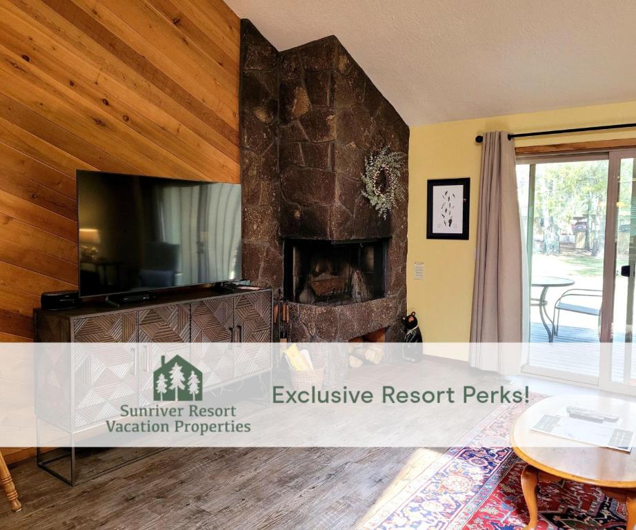 a living room with a fireplace and a tv at 3 Quelah Condo in Sunriver