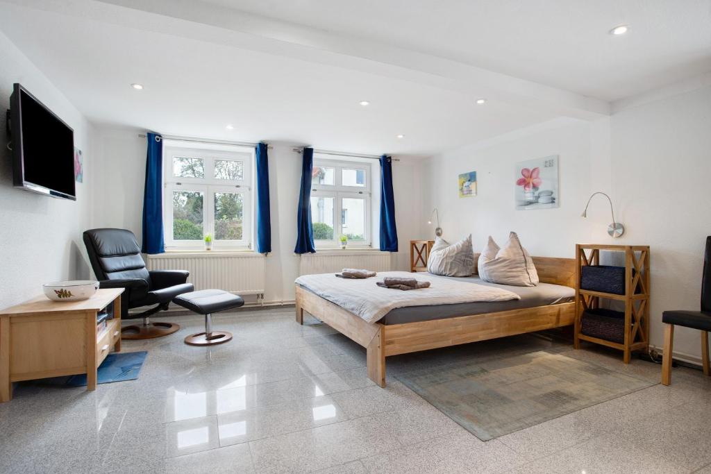 a bedroom with a bed and a desk and a chair at Bäckerhus - Ferienwohnung 1 in Wiek auf Rügen
