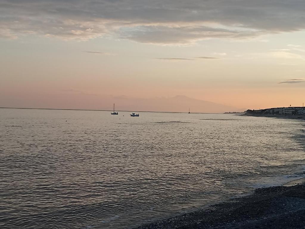 a view of the ocean with two boats in the water at Casa Azzurra 56 in Bova Marina