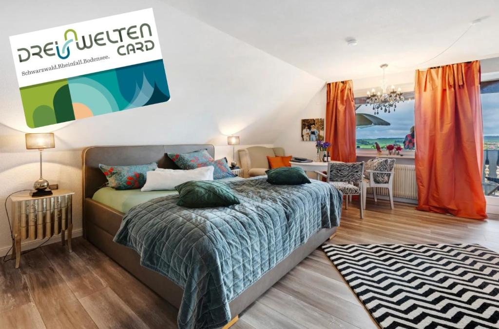 a bedroom with a bed and a table with a view at Appartement am Kirnbergsee in Bräunlingen