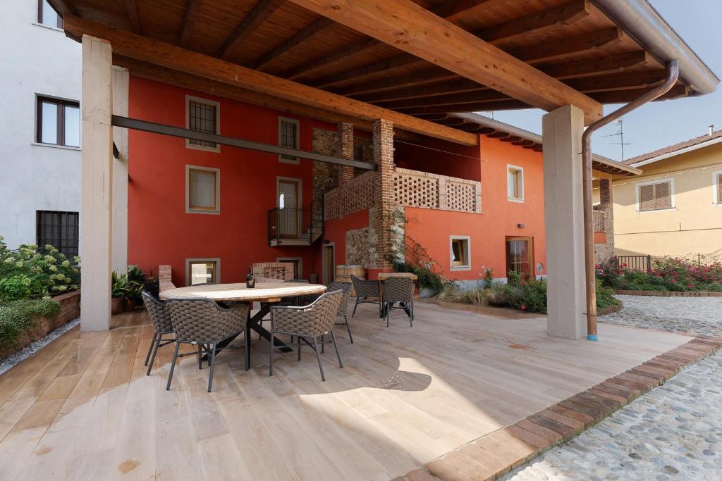 a patio with a table and chairs and a building at Decanter House in Borgomanero