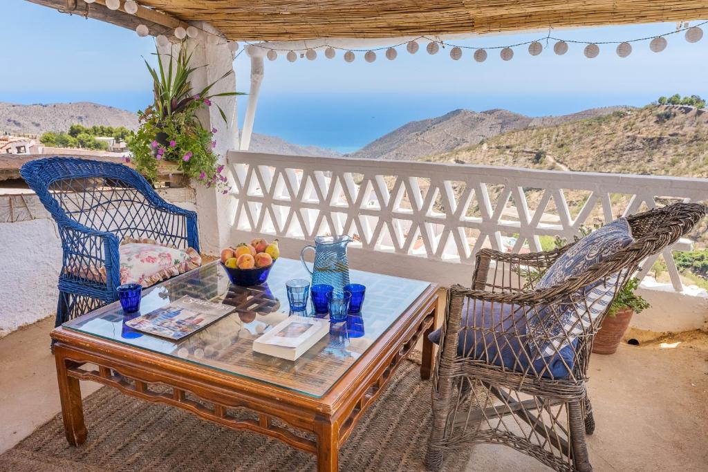 a table and two chairs on a patio with a view at Buhardilla La Prensa in Sorvilán