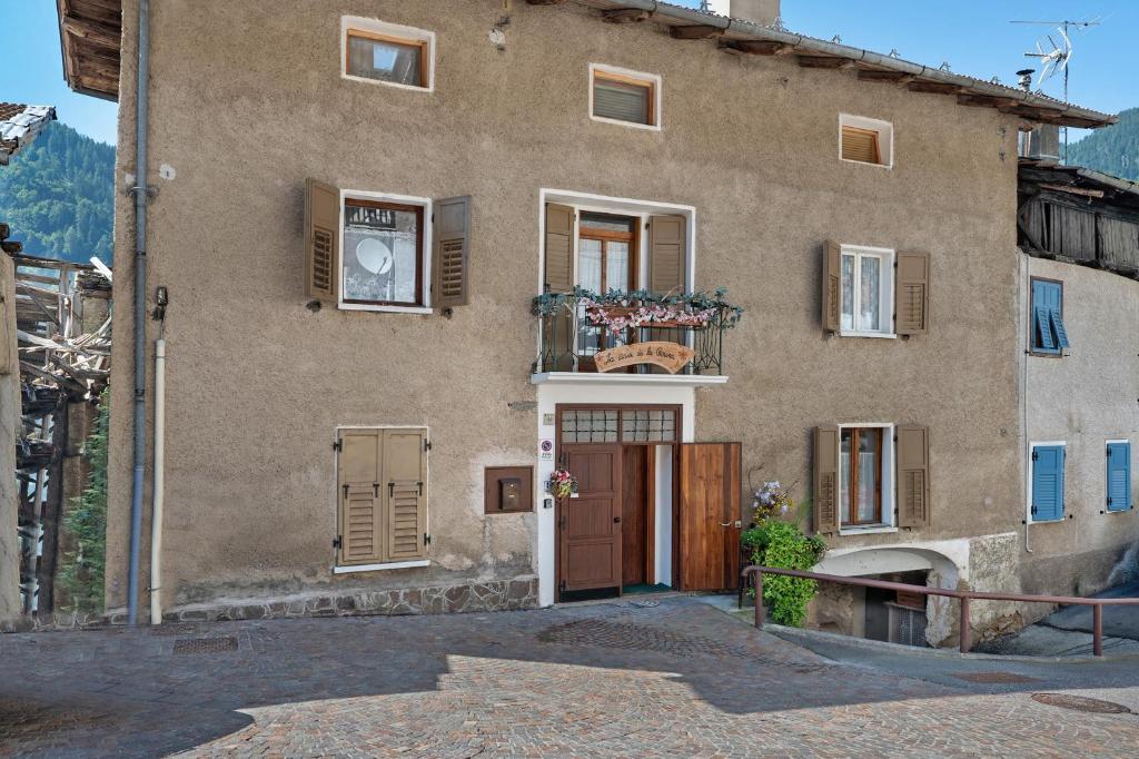 a large building with a door and a balcony at Casa della Rosina in Bresimo