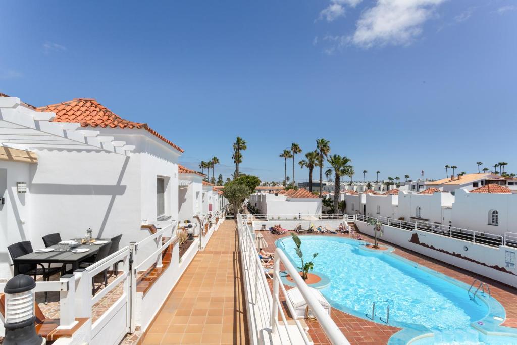 a view from the balcony of a resort with a swimming pool at La Casita Encantada in Corralejo