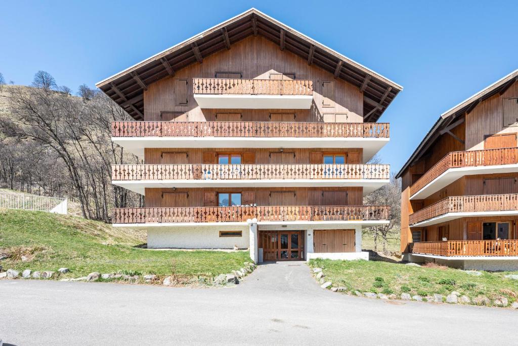 a building with balconies on the side of it at Les arolles in Valloire