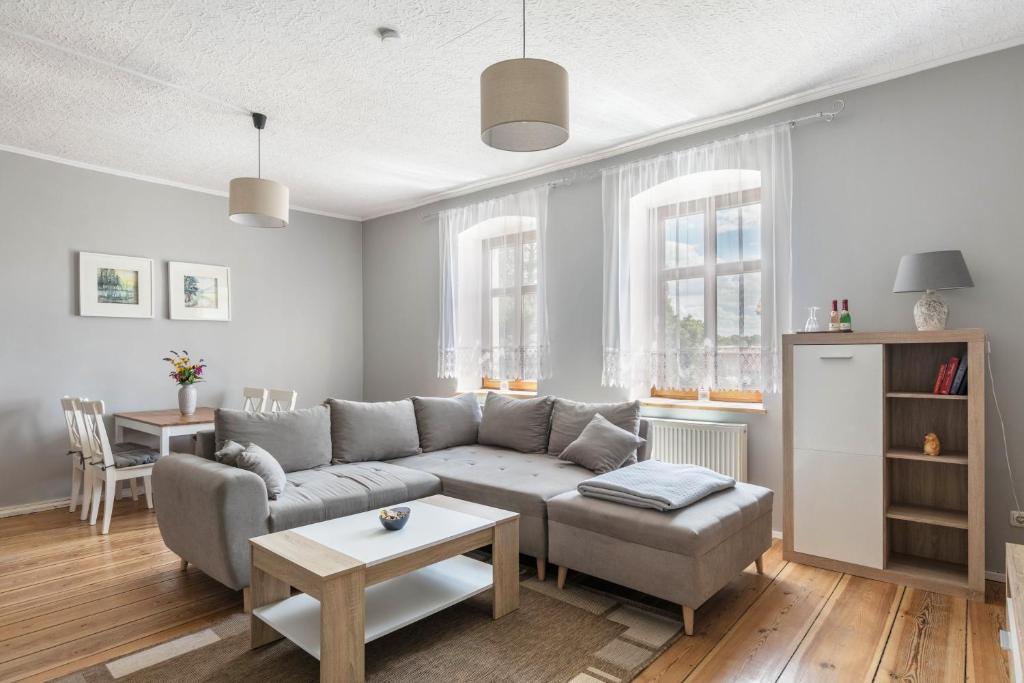 a living room with a couch and a table at Ferienwohnung mit großem Garten in Lindow