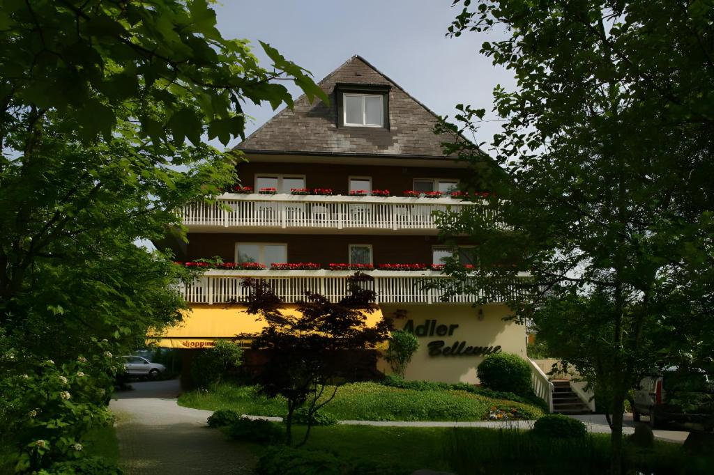 a large house with flowers on the front of it at Ferienhaus Adler Bellevue in Hinterzarten