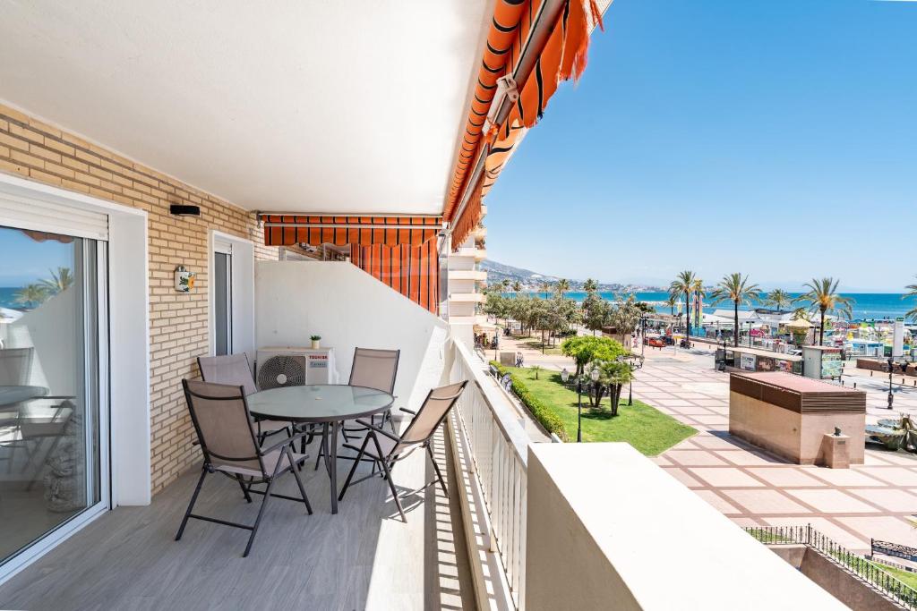 a balcony with a table and chairs and a view of the ocean at Paraiso in Fuengirola
