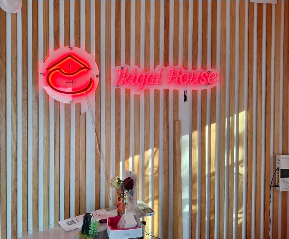 a ksecret house sign on the wall of a room at Ikigai House in Seville