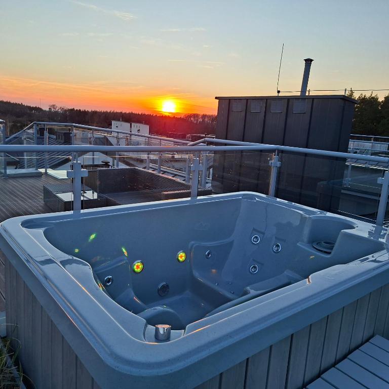 a blue bath tub sitting on top of a roof at Apartamenty Przy Wydmie Dębina in Debina