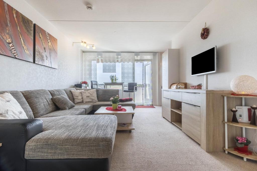 a living room with a couch and a tv at Ferienwohnung Harzblick in Altenau