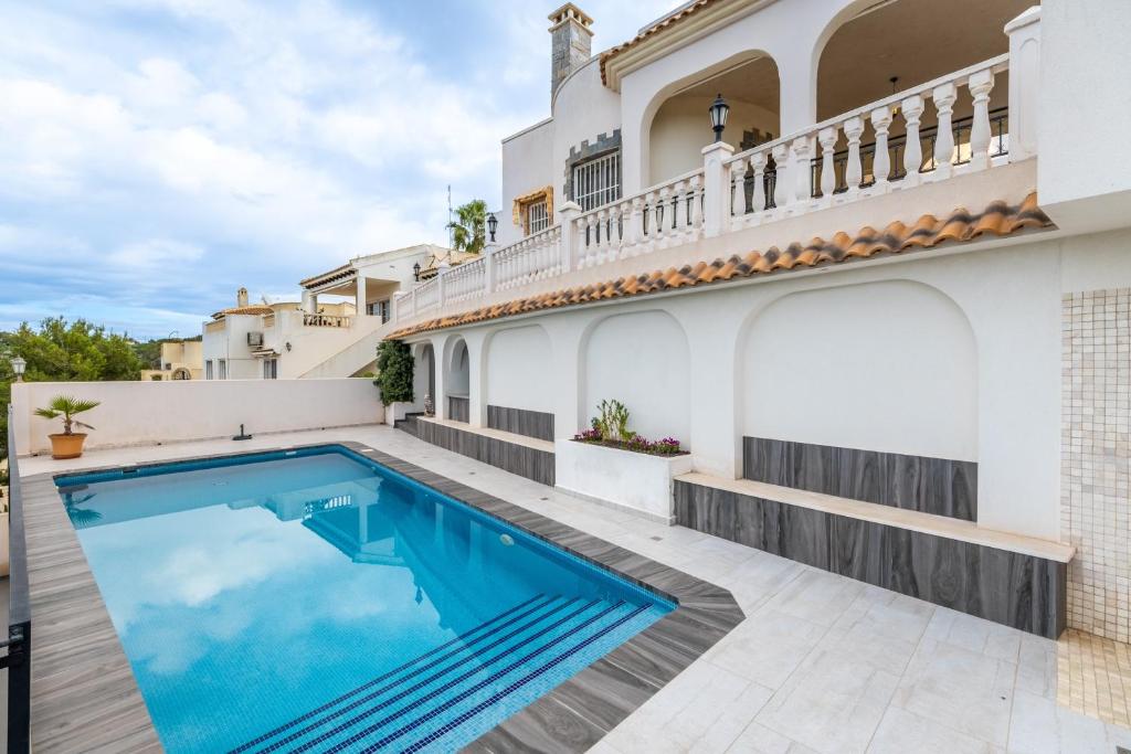 a swimming pool in the backyard of a house at Las Ramblas in Orihuela