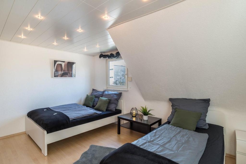 a bedroom with a bed and a couch in a room at am Hirnach in Sindelfingen
