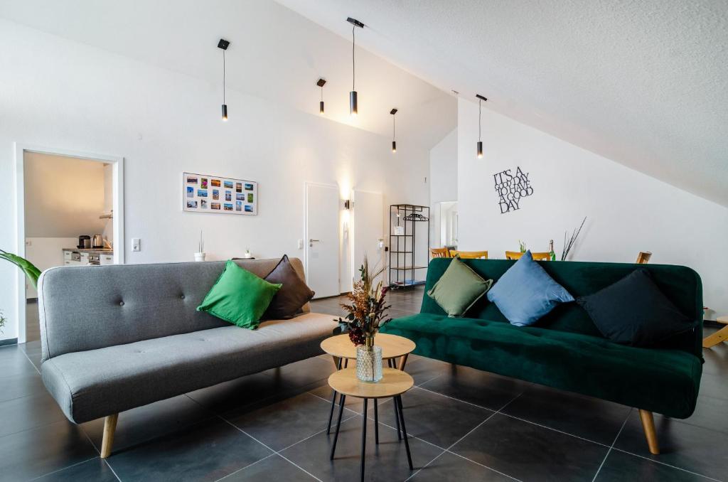 a living room with two couches and a table at Sonne und Mehr in Stockach