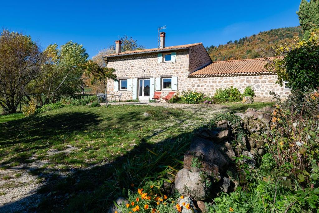 a stone house on a hill with a garden at Le Mas Saint Victor in Saint-Victor