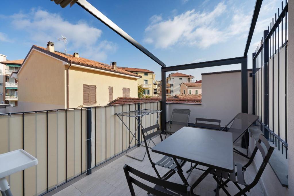 a balcony with a table and chairs on it at Cinema Boutique Apartment Sestri in Sestri Levante