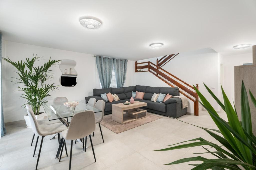 a living room with a couch and a table at Villa en Las Caletillas in Punta Larga