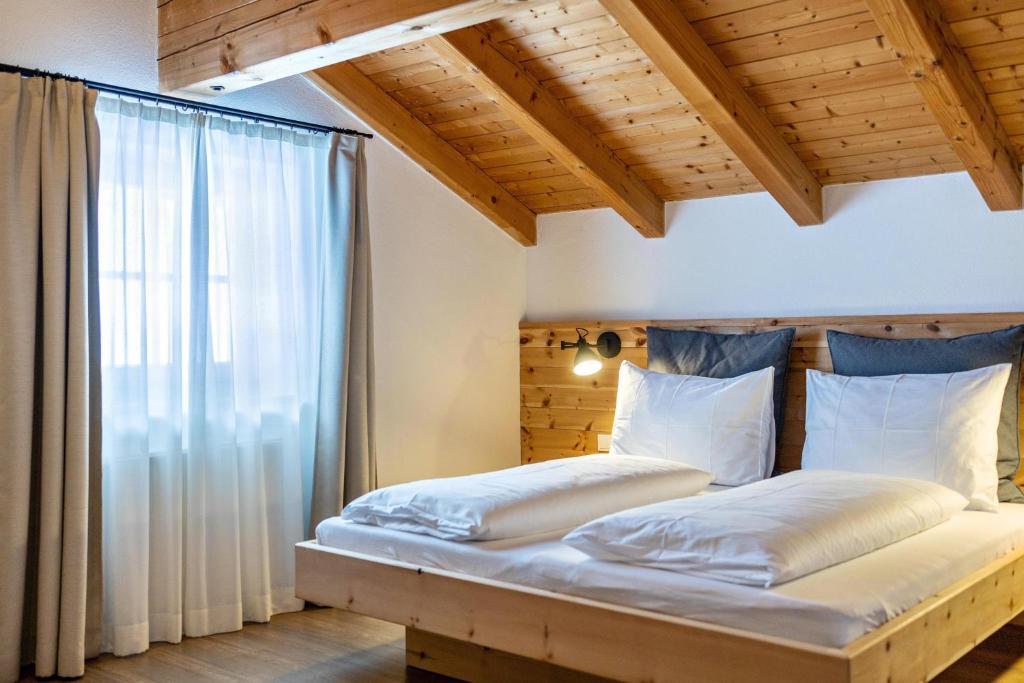 a bedroom with a bed with a large window at Mountain Residence Kasern Nr 5 in Predoi