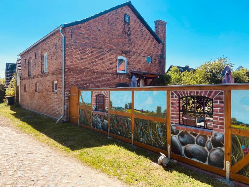 a building with a mural on the side of it at Alter Stall in Melzow
