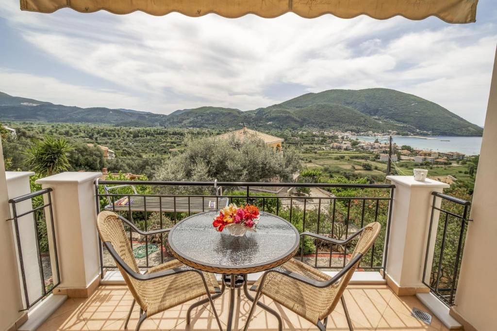 a table and chairs on a balcony with a view at Panorama studios 3 in Póndi