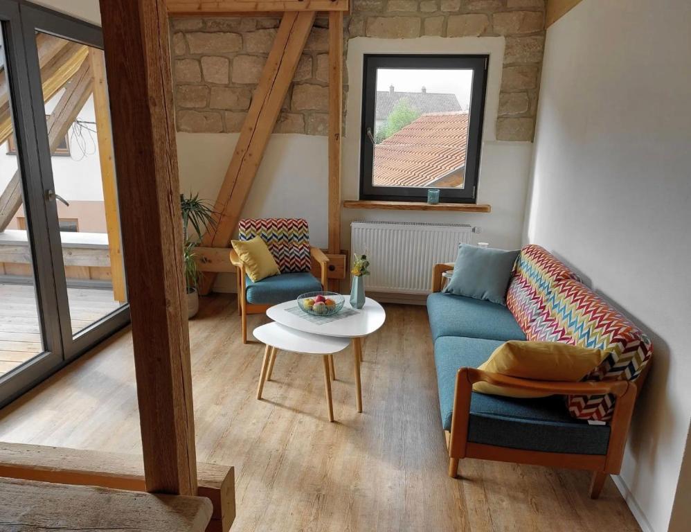 a living room with a couch and a table at Ferienwohnung Am Eselsburger Tal in Herbrechtingen